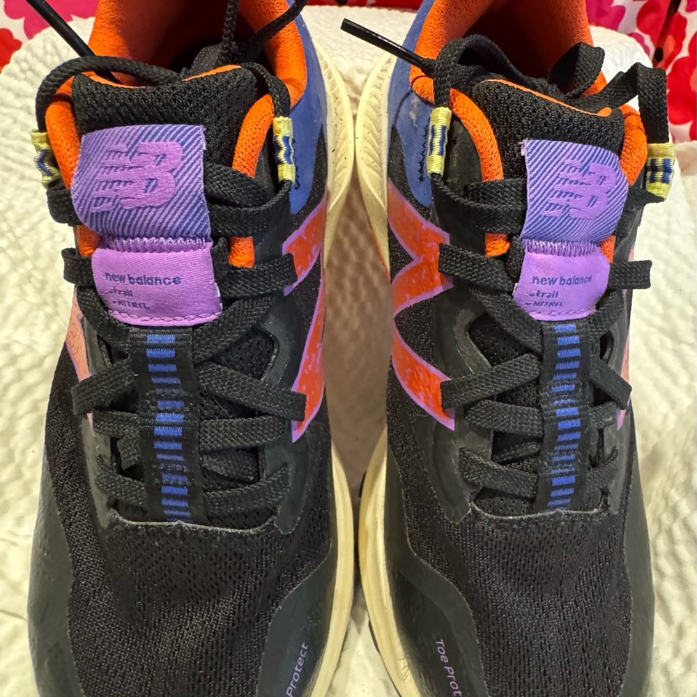 New Balance Black Running Shoes with Purple and Orange Accents